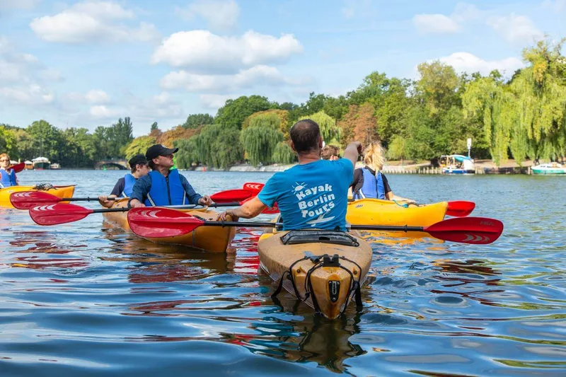 Team kayaking on a Berlin waterway in summer