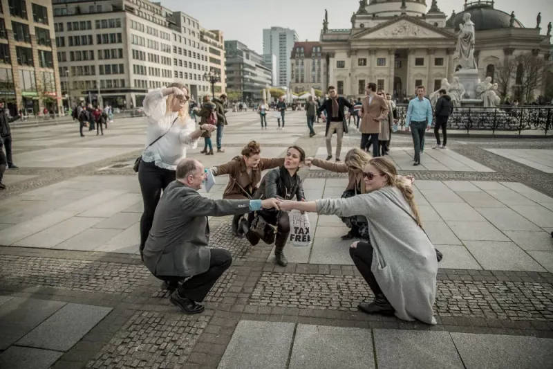 Team building a human sculpture on Gendarmenmarkt as a creative task