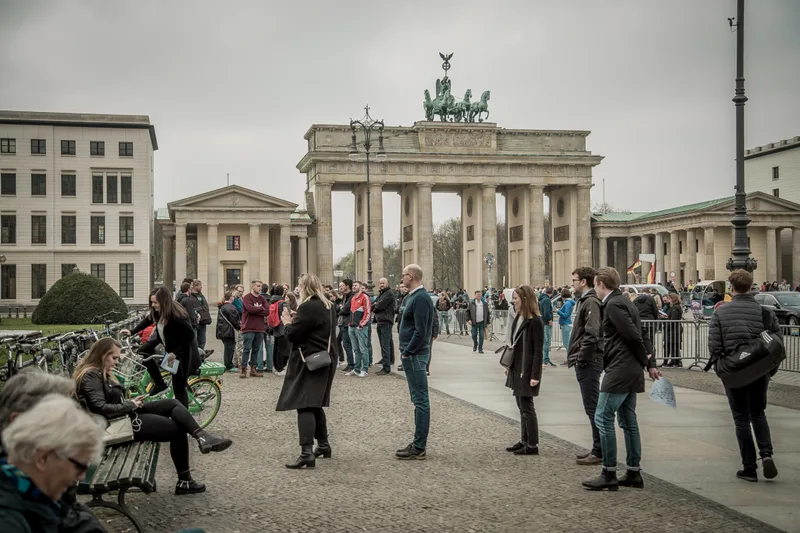 Corporate teams gathering on Pariser Platz in front of the Brandenburg Gate before a treasure hunt