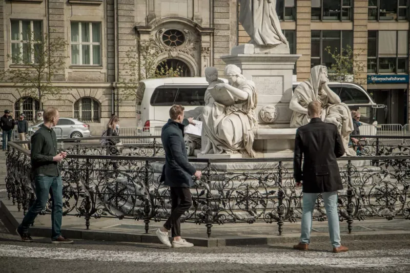 Team searching for details at the Schiller Monument on Gendarmenmarkt