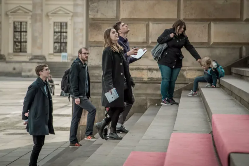 Participants searching the steps for a hidden clue