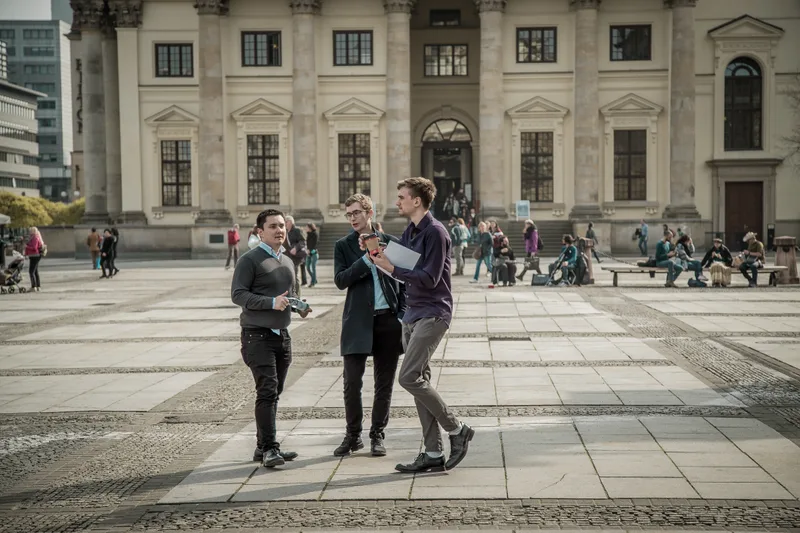 Treasure hunt team discussing a clue on Gendarmenmarkt