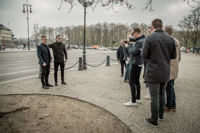 Treasure hunt team filming a photo task on the square in front of the Brandenburg Gate